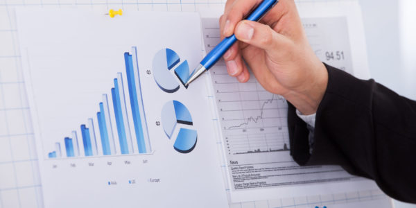 Cropped image of businessman analyzing graph with pen